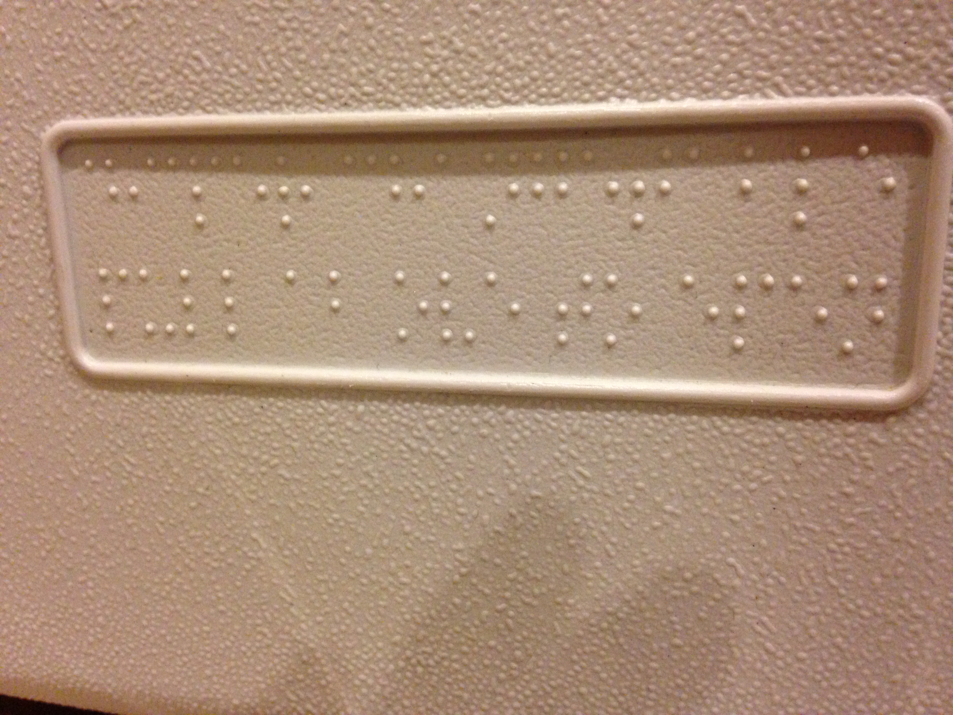 Close-up of a plastic braille label